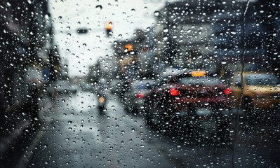 Morning traffic on rainy day,view through the windshield during rain storm with selective focus.