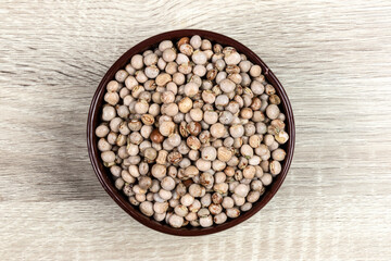 pigeon pea or tuvar beans or guandu bean (Cajanus cajan) seeds in ceramic bowl on the wooden table in Brazil