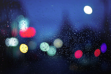 Blurry of street life at night with bokeh light.View through the wind shield during hard rain fall with selective focus.