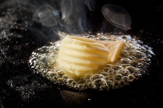 Piece of butter frying on stove