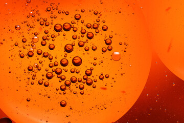 oil bubbles with water on glass