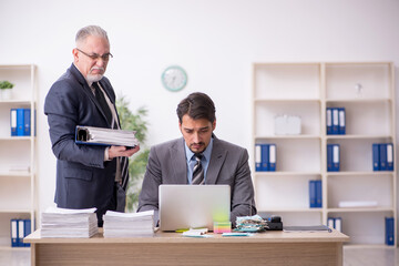 Two male employees in bullying concept
