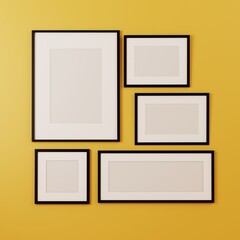 Group of blank black picture frame mock up on the yellow wall. 3d rendering.