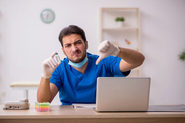 Young male doctor in vaccination concept