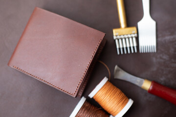 Brown genuine leather men wallet on leather background