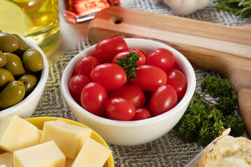 Appetizer jars with cheese, olives and cherry tomatoes