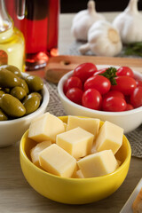 Appetizer jars with cheese, olives and cherry tomatoes