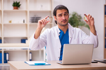 Young male doctor in vaccination concept