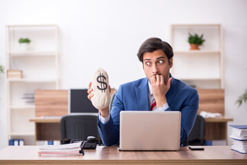 Young male employee in remuneration concept at workplace