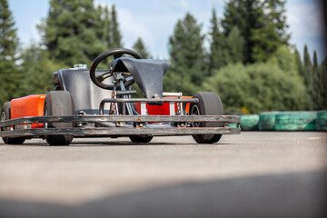 A go-karting car is standing on the highway and waiting for the driver. Go-karting cars for children and adults.