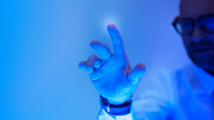 Man touching the futuristic blue screen