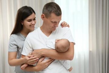 Happy family with their cute baby at home