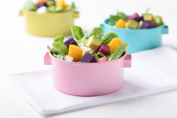 Fresh fruit and vegetable salad with avocado, dragon fruit, pumpkin, radish, lettuce and corn salad. Concepts of healthy food, vegetarian and lifestyle trends.