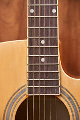 Obraz premium Detail of the body of a light wood guitar, soundhole, fretboards and strings.