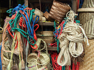 Halters and bridles, different ropes in blue, green and red colors along with wicker natural...