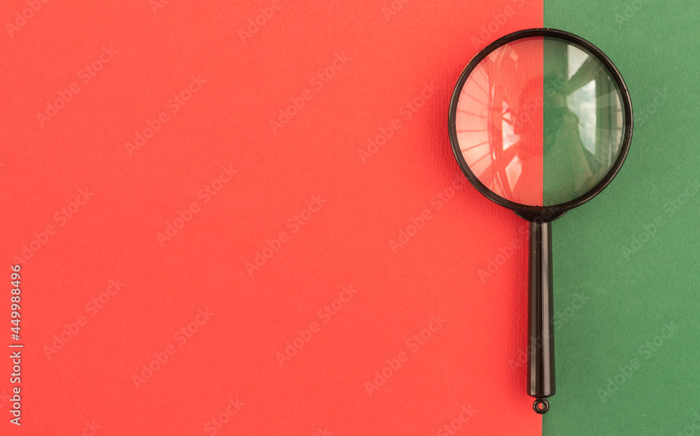Poster magnifier on minimalistic red background with copy space for text.