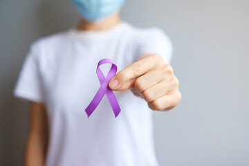 Hand holding purple Ribbon for Pancreatic, Esophageal, Testicular cancer, world Alzheimer,...