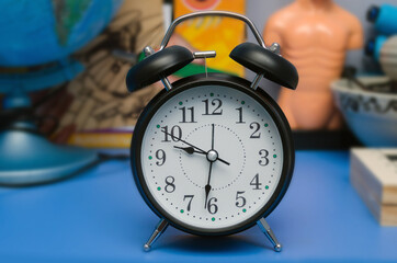 metal alarm clock on the table. Time 9 hours 31 minutes