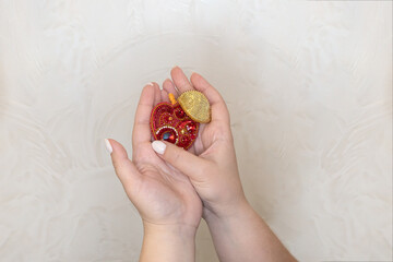 A woman's hand holds a beaded brooch. The elegance and beauty of handicrafts. 