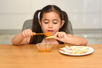 Little Girl Eating Apple With Honey. Healthy Eating For Children.