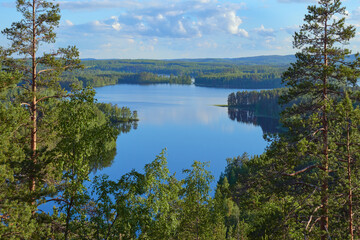 Summer view from the Neitvuori mountain in Finland to the lake and forest.