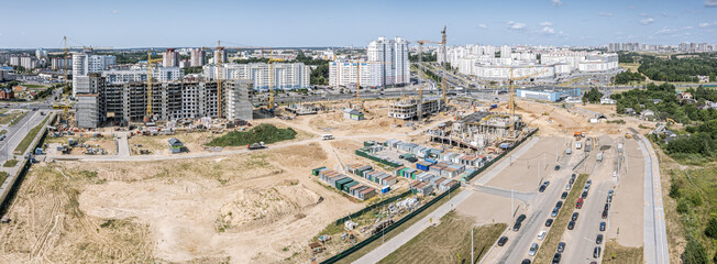 large urban construction site. new high-rise apartment buildings under construction. lot of working...