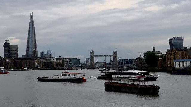Timelapse of Boats in front of Tower Bridge next to the Shard along the River Thames, England.