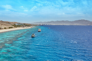 Pleasure boat for travel in the Red Sea, in Israel. Against the backdrop of the coastline and mountains