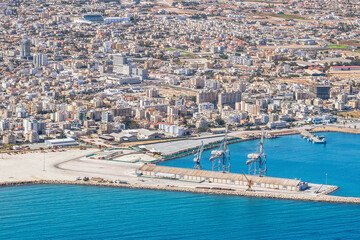 Sea port city of Larnaca, Cyprus. View from the aircraft to the coastline, beaches, seaport and the architecture of the city of Larnaca.