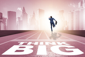 Businessman in think big concept on running track