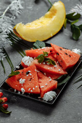 Pieces of fresh red watermelon on a black plate