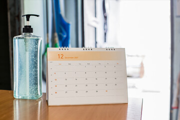 White desk calendar on dark wooden table, planning concept.	