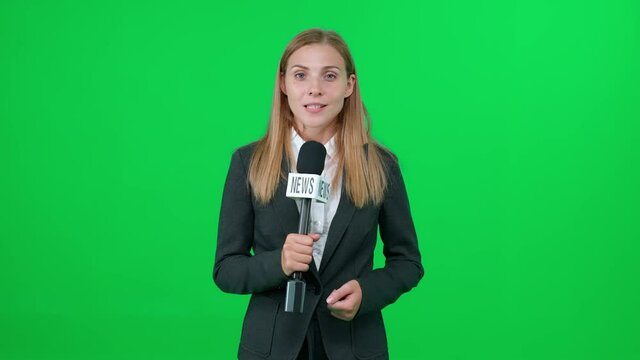 Breaking news, female news reporter speaks into a microphone on a green background and looks into the camera, template for TV news agencies, woman journalist at work, chromakey.