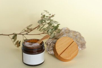 Body scrub of ground coffee, sugar and coconut oil in glass jar on table, homemade cosmetic for peeling and spa care