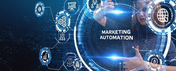Planning marketing strategy. Business, Technology, Internet and network concept. Young businessman shows the word: Marketing automation