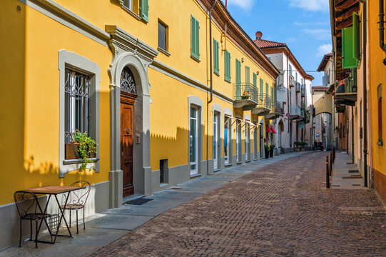 Fototapeta Narrow street and colorful houses in Alba, Italy.