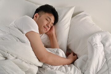 Handsome Young Asian man sleeping in bed