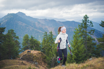 Female running in mountains. Woman trail runner cross country running