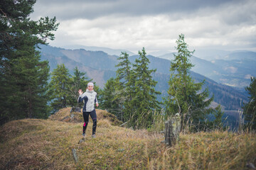 Female running in mountains. Woman trail runner cross country running