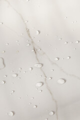 Water drops over marble stone texture background. Copy space photography