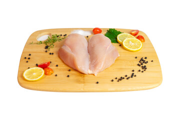 Raw chicken breast fillet with slice lemon and spices on wooden white background.