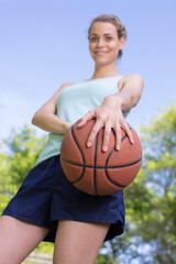 low angle view of a woman holding a basketball