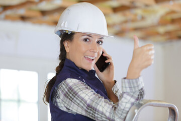 engineer construction worker woman smiling broadly showing thumbs up