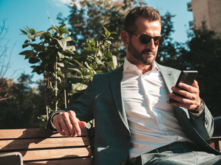 Handsome confident stylish hipster lambersexual model.Modern man dressed in elegant suit. Fashion...