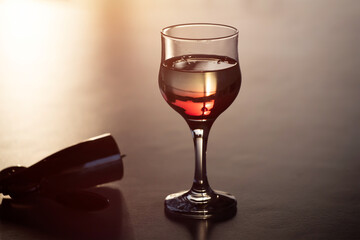 Glass of red wine in the sunset.
