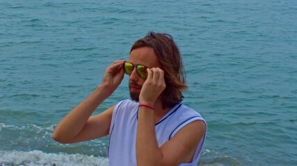 Man with sunglasses at sea. Resort and travel tour on holidays