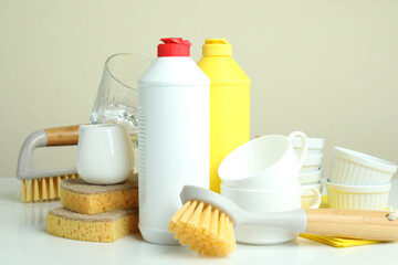 Concept of different Dishwashing detergent accessories on white table