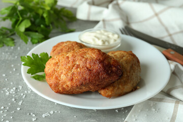 Concept of tasty food with cutlets on gray textured table