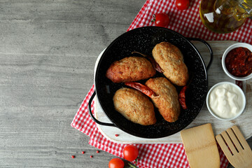 Concept of tasty food with cutlets on gray textured table