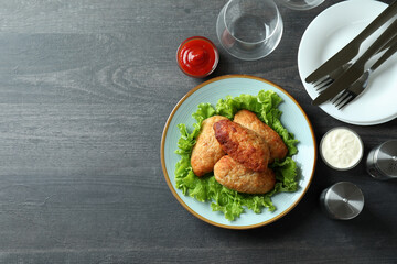 Concept of tasty food with cutlets on dark wooden table